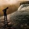 Photo: Man standing at the edge of a waterfall.jpeg